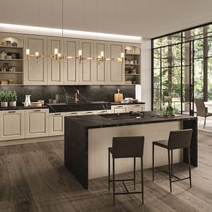 Miljöbild på modern platsbyggt kök med ramlucka. Köksö med svart sten bänkskiva.