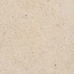 En produktbild på en beige natursten med mörkare prickar till köksbänkskiva.